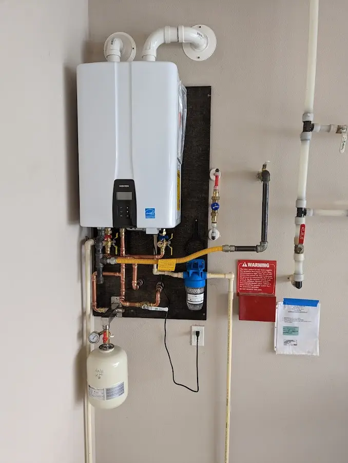 Professional plumber installing copper piping in a Ave Maria home